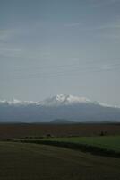 clouds over the mountains and farms photo