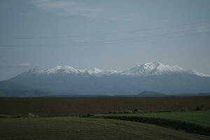 clouds over the mountains and farms photo