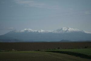 clouds over the mountains and farms photo