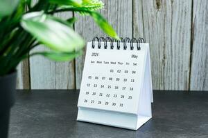 White May 2024 calendar on wooden desk. 2024 New Year Concept photo