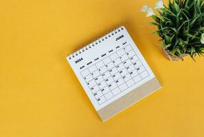 June 2024 desk calendar on yellow background. Directly above. Flat lay. photo