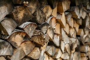 old firewood stacked in the woodpile photo