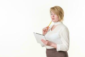 Thoughtful businesswoman with pencil, clipboard looking away. Experienced middle-aged business woman photo