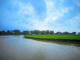 Sunny summer landscape with river.Green hills,fields and meadows. photo