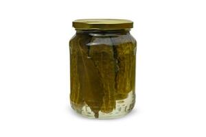 Glass jar with pickled cucumbers on white background. photo