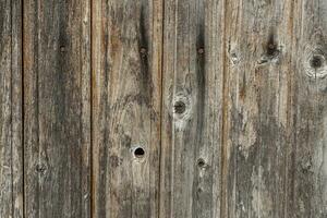 Wooden wall from old boards with knots and rusty nails, Wall panel, natural background vertical wood panel photo