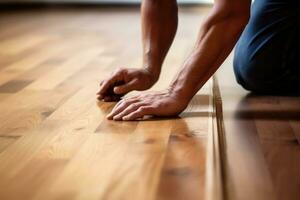 A worker's hands installing a new hardwood floor. Generative AI photo