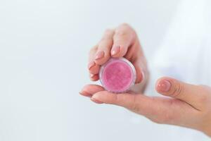 Female hands holding face powder on a white background. Isolated background. Space for text photo