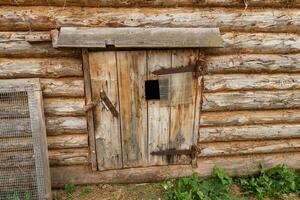 Animal stall. Closed door in a wooden barn. Entrance to the animal shed photo