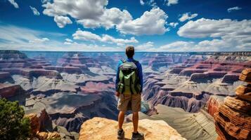 Awe-inspiring shot of a lone traveler gazing out at the vast expanse of the canyon photo