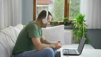 Man listening to music with headphones is unhappy and sad. video