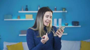 ung flicka fröjd läsning de Bra Nyheter på de telefon. video