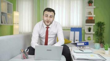 The businessman is amazed by what he sees on the laptop screen and says wow. video