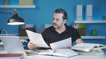 Man looking at important papers is stressed and worried. video