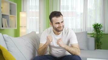 Rejoicing in good events, the young man is happy and cheerful. video