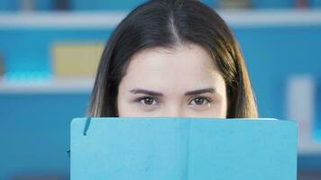 Bookworm, eyes of young woman reading book taking notes. video