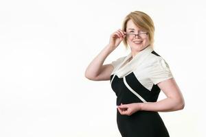 Portrait of feminine mature businesswoman with glasses looking at camera and lowering her glasses photo