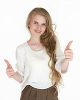 Happiness blonde woman showing thumbs up with both hands, looking at camera on white background photo