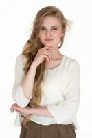 Portrait of young woman 21 years old looking at camera. Blond woman dressed in white blouse photo