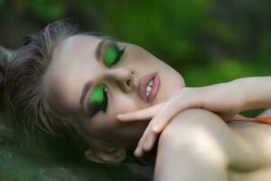 Close-up portrait of European woman with eyes closed relaxation in summer forest, enjoyment outdoors photo