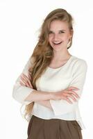 Confident young businesswoman smiling and looking at camera, crossed arms on white background photo