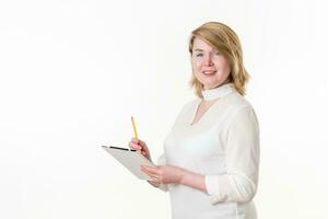 Portrait businesswoman looking camera, writes on clipboard with pencil. Concept white collar worker photo