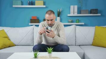 Lonely man looking at phone gets emotional. video