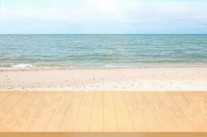 Blank wooden table with white sand beach and sea landscape background for product display montage photo