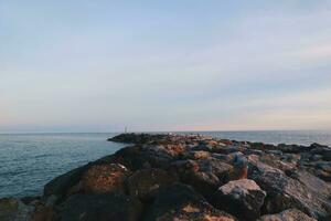 Landscape of sea and beach during sunset night time with vanilla sky photo