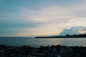 Landscape of sea and beach during sunset night time with vanilla sky photo