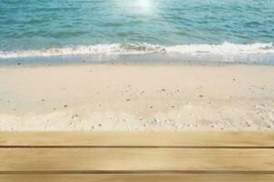 Blank wooden table on the beach and sea landscape background for product display montage photo