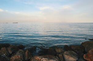 Landscape of sea and beach during sunset night time with vanilla sky photo