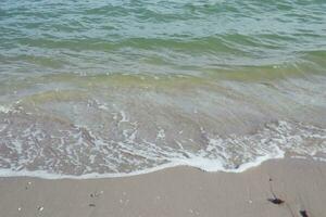 footprints in the sand, Land scape of beach and sea, blue wave and white sand photo