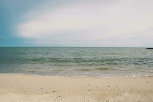 footprints in the sand, Land scape of beach and sea, blue wave and white sand photo