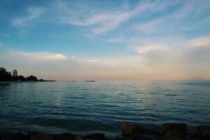 Landscape of sea and beach during sunset night time with vanilla sky photo