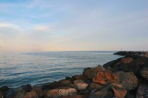 Landscape of sea and beach during sunset night time with vanilla sky photo