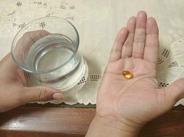 Taking medicine with glass of water photo