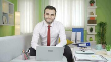 Happy businessman smiles at the camera. video