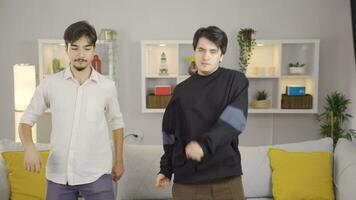 Friends dance funny and witty together at home. video