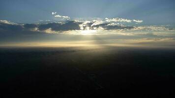 Aerial view of foggy hills covered by forest. Beautiful landscape in the mountains at sunrise. Colourful sunrise in forested mountain with fog. Morning dawn in the mountains. photo