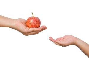 Woman giving apple to little girl from hand to hand on white background. photo