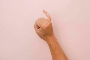 Little finger of male hand against pink background, meaning reconciliation. keeping promise sign. photo