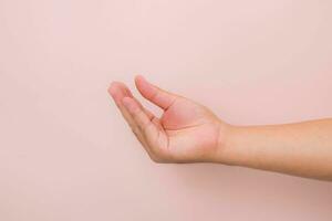 Hands gesture like picking up something isolated on pink background. photo