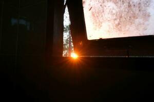 The sunlight shines through the window. Rays of setting sun shines through the window. photo