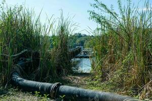 Pipe is installed along the bridge on the pipe support. Water steel pipes for community utilities. photo