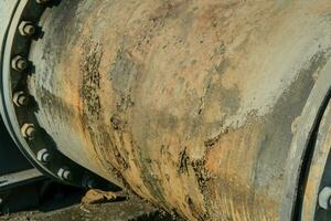 Pipe is installed along the bridge on the pipe support. Water steel pipes for community utilities. photo