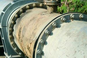 Pipe is installed along the bridge on the pipe support. Water steel pipes for community utilities. photo