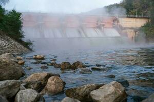 Morning scenery at Kiew Lom Dam, Lampang, Thailand. Hydroelectric dam, floodgate with water flowing through the gate. Dam with hydroelectric power plant and irrigation. photo