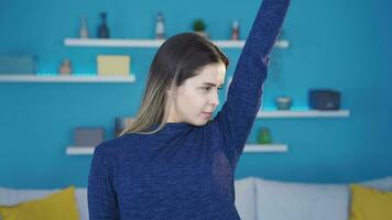 Sweaty young woman applying deodorant to prevent the smell of sweat. video