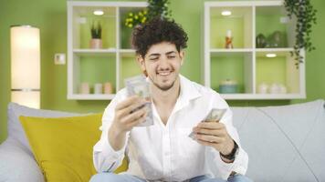 Happy young man counting money. video